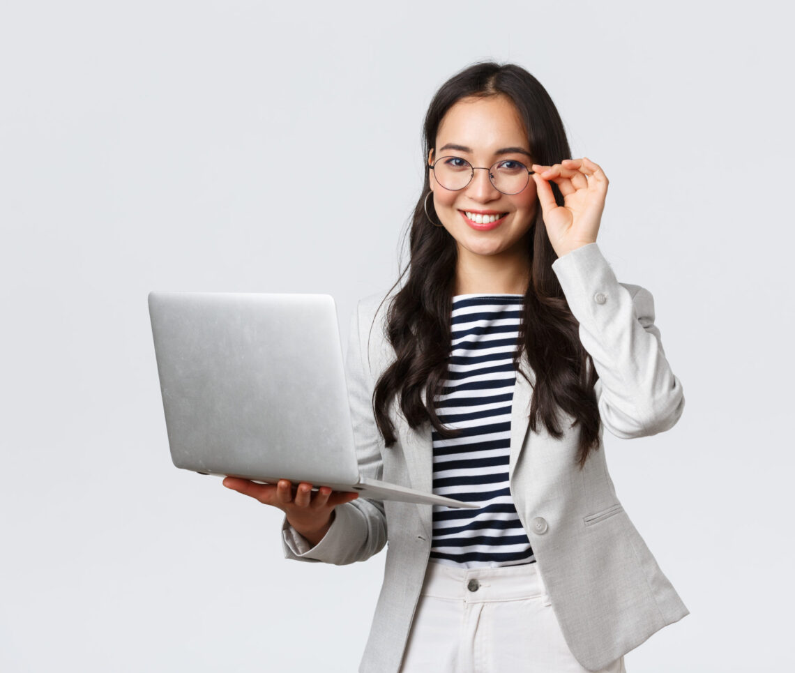 Business, finance and employment, female successful entrepreneurs concept. Confident smiling asian businesswoman, office worker in white suit and glasses using laptop, help clients
