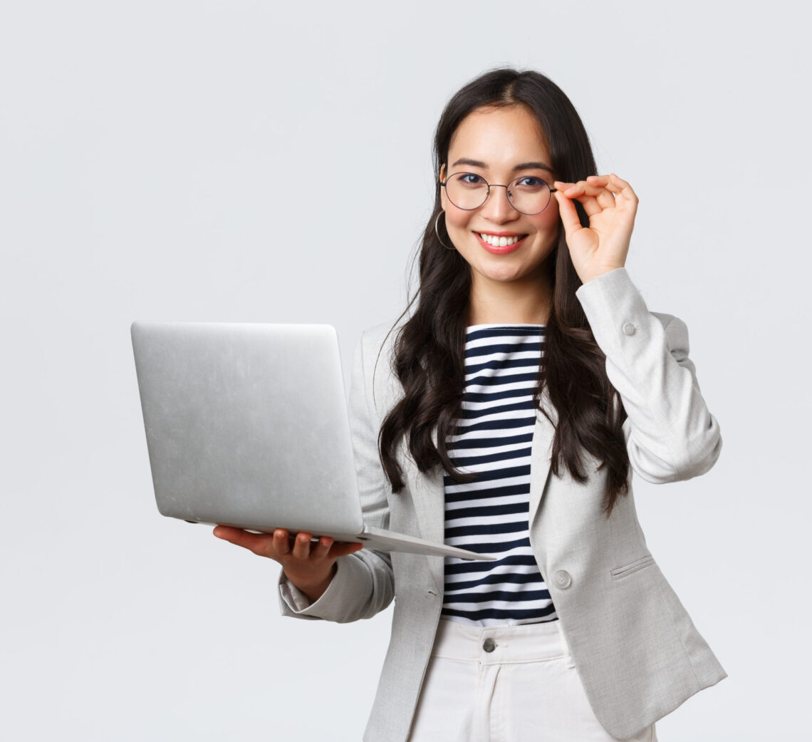 Business, finance and employment, female successful entrepreneurs concept. Confident smiling asian businesswoman, office worker in white suit and glasses using laptop, help clients