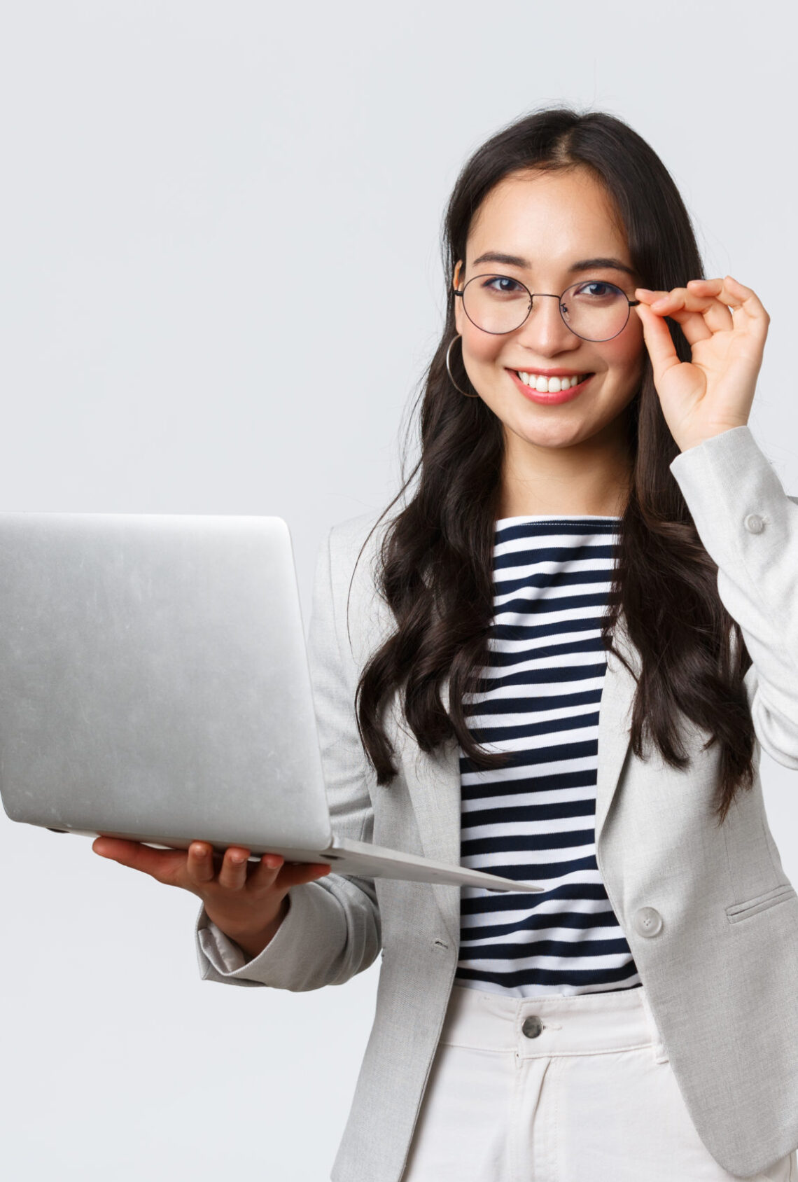 Business, finance and employment, female successful entrepreneurs concept. Confident smiling asian businesswoman, office worker in white suit and glasses using laptop, help clients