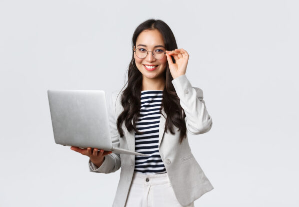 Business, finance and employment, female successful entrepreneurs concept. Confident smiling asian businesswoman, office worker in white suit and glasses using laptop, help clients