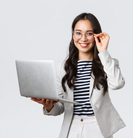 Business, finance and employment, female successful entrepreneurs concept. Confident smiling asian businesswoman, office worker in white suit and glasses using laptop, help clients