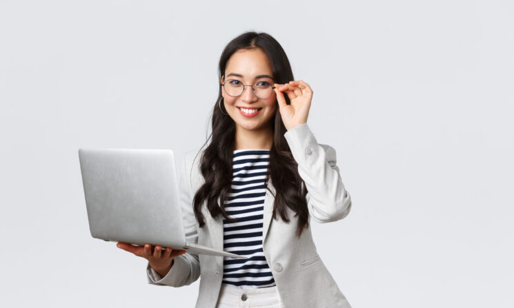 Business, finance and employment, female successful entrepreneurs concept. Confident smiling asian businesswoman, office worker in white suit and glasses using laptop, help clients